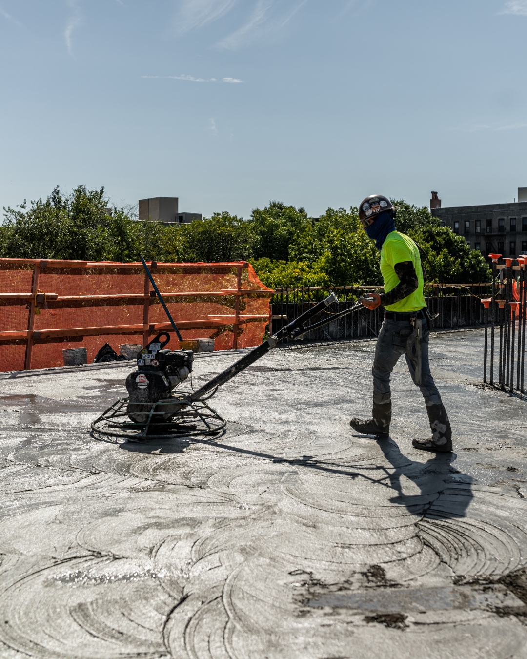 Power trowel finishing fresh concrete slab — self-performed work