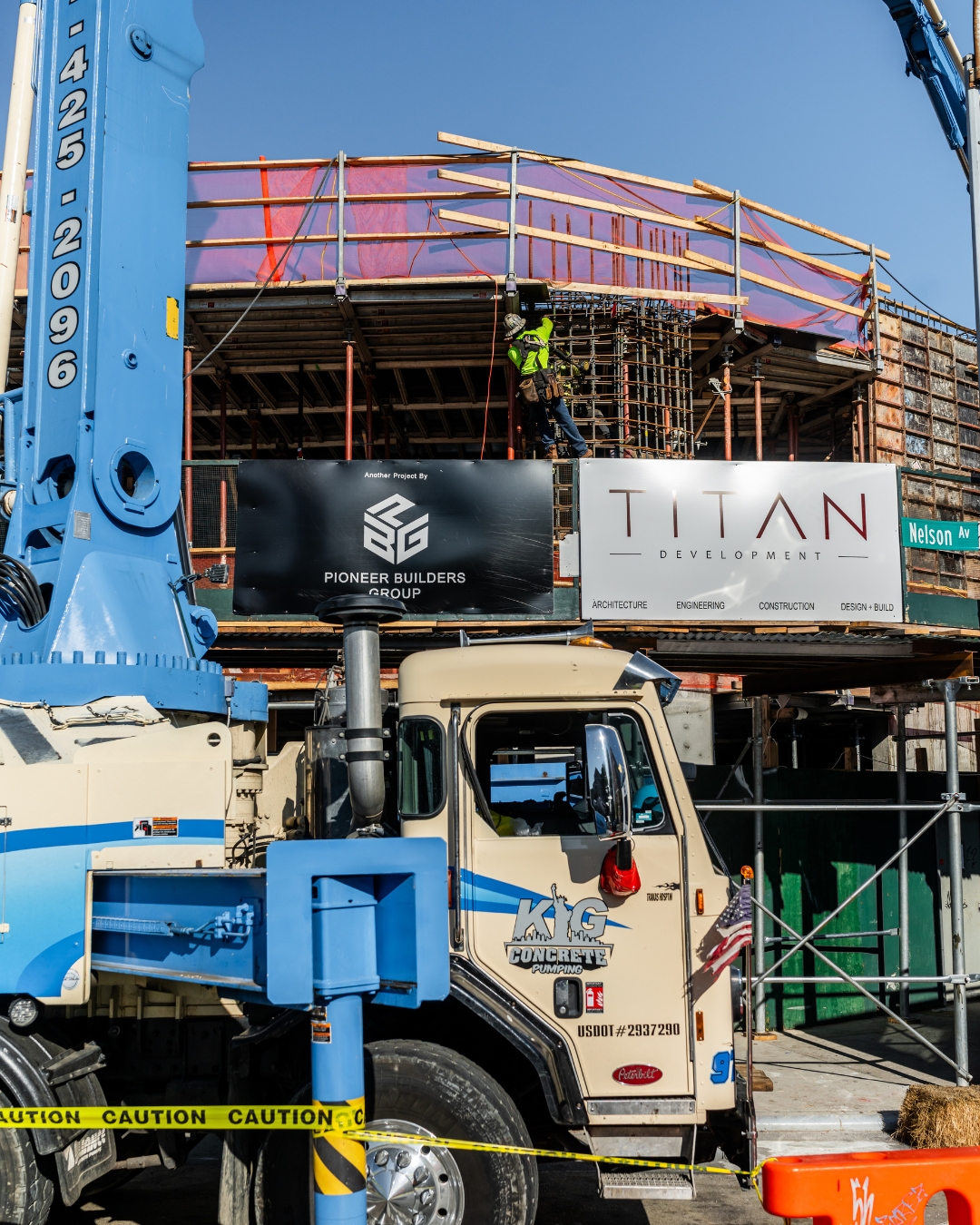 Titan Development jobsite signage with active construction