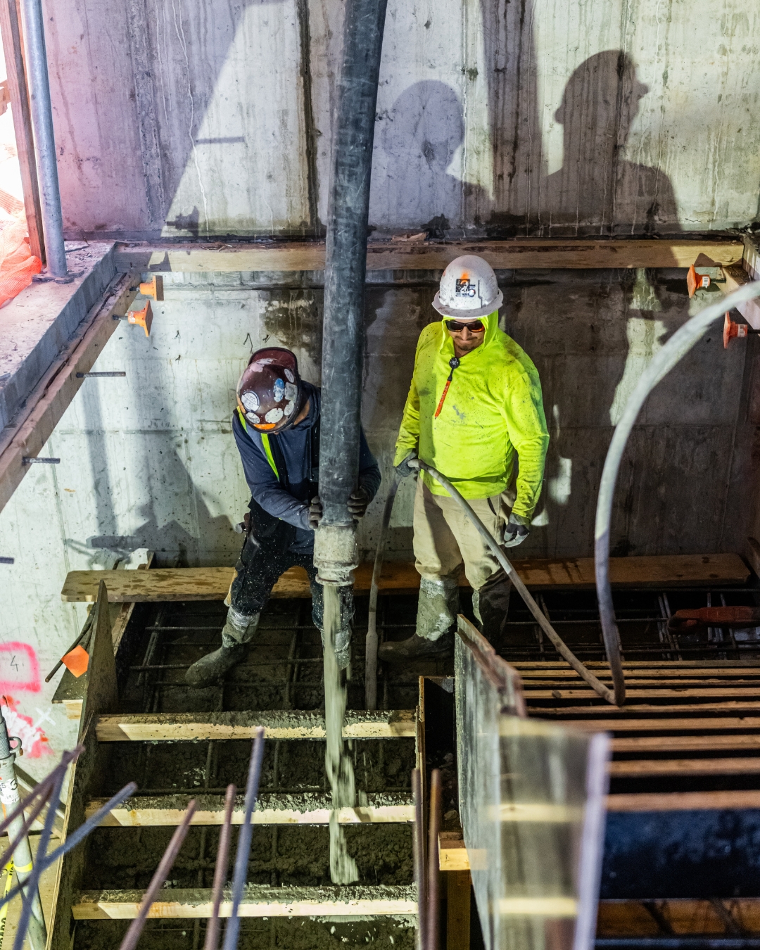Night concrete pour in stairwell shaft — Titan crew at work